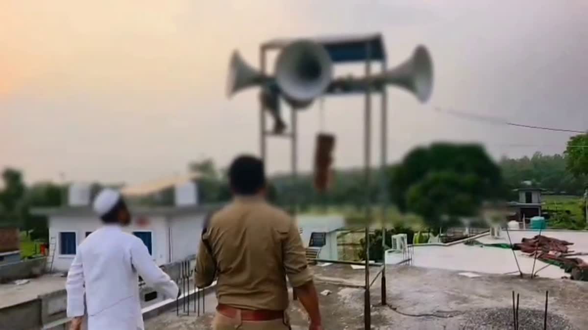 Police officials removing loudspeakers from a religious place during the Dehradun noise pollution enforcement drive.