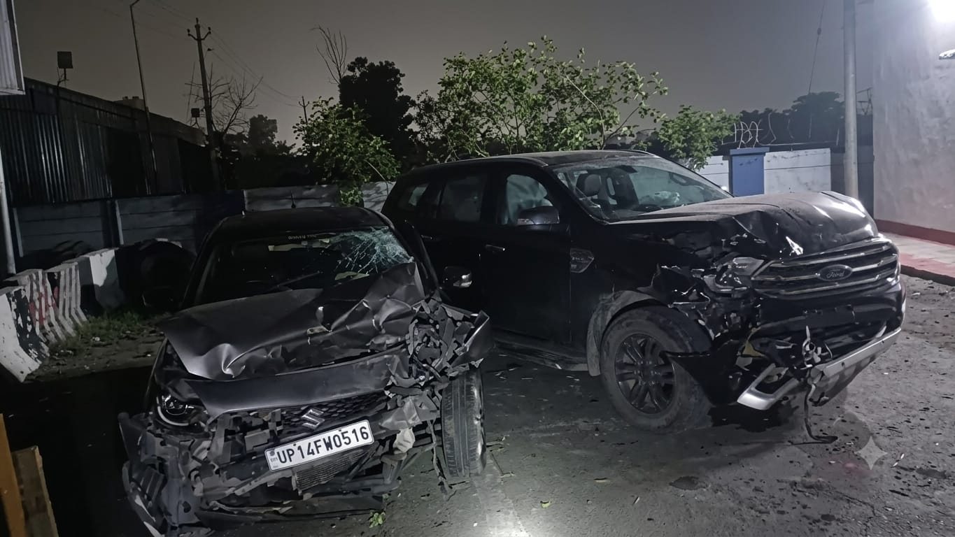 Two heavily damaged cars parked at night after a head-on collision on the Tanda Highway in Pantnagar.