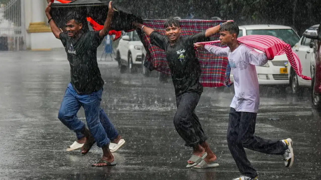 IMD Weather Updates showing heavy rain alert across Delhi, Uttar Pradesh, Bihar, Uttarakhand and 14 Indian states with monsoon clouds and rainfall forecast.