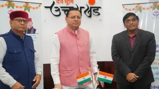 CM Dhami transfers social security pension funds directly into beneficiaries accounts during a state event
